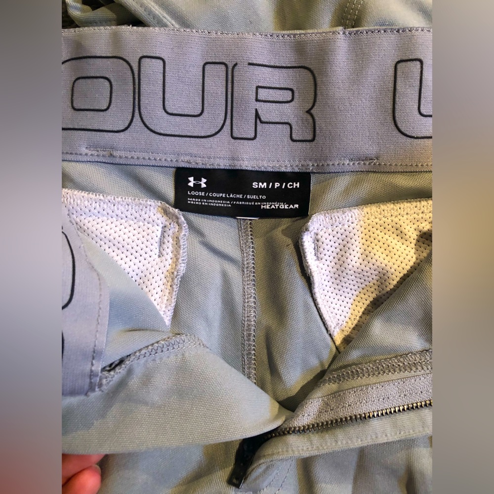 Under Armour baseball pants. No holes, slight stain on one leg bottom.